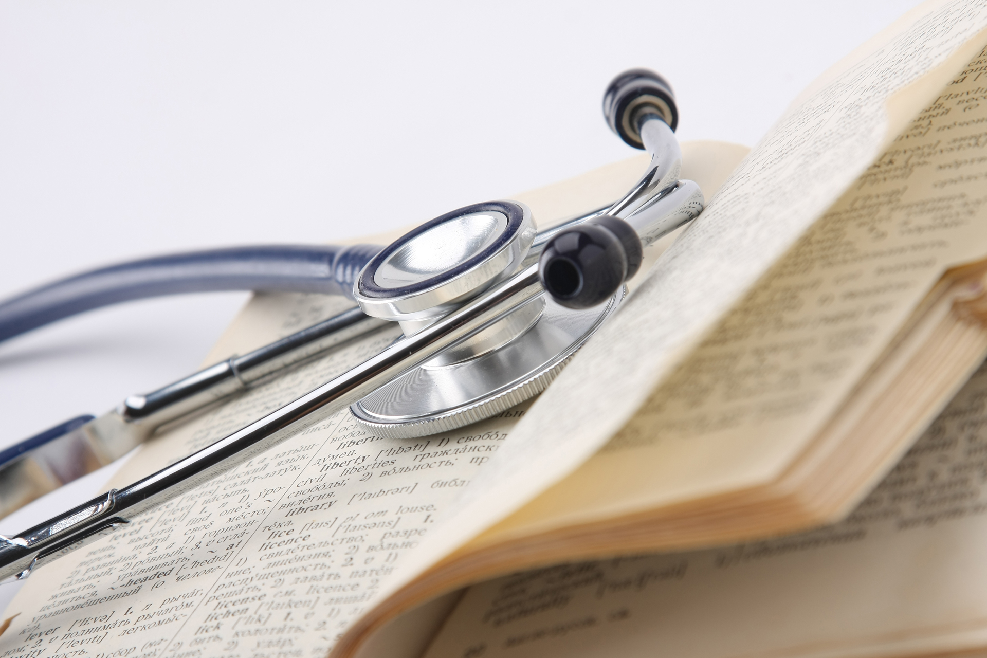 A stethoscope on an opened book, closeup
