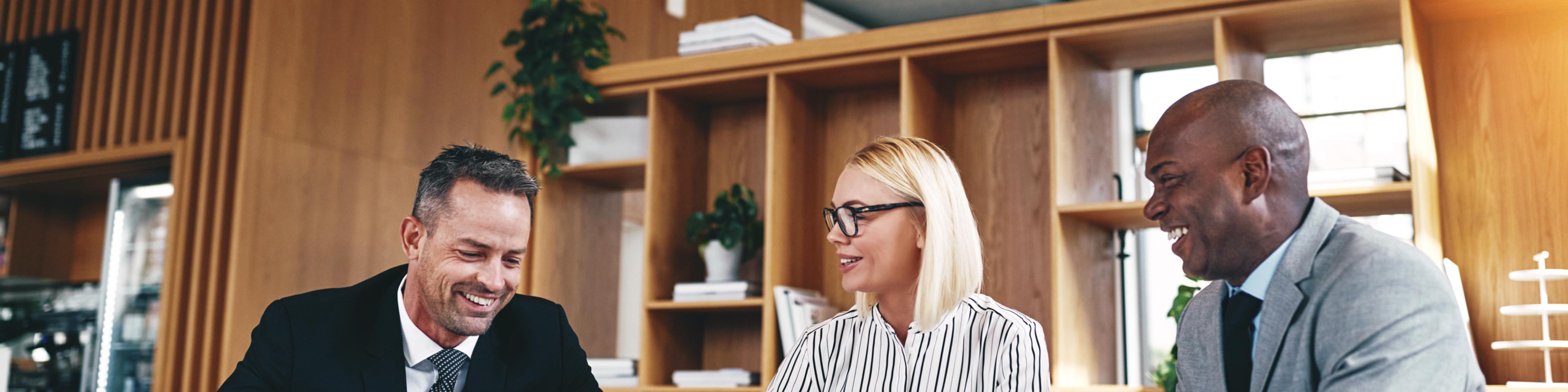 alt="diverse team of business co-workers excited to collaborate in their place of work"