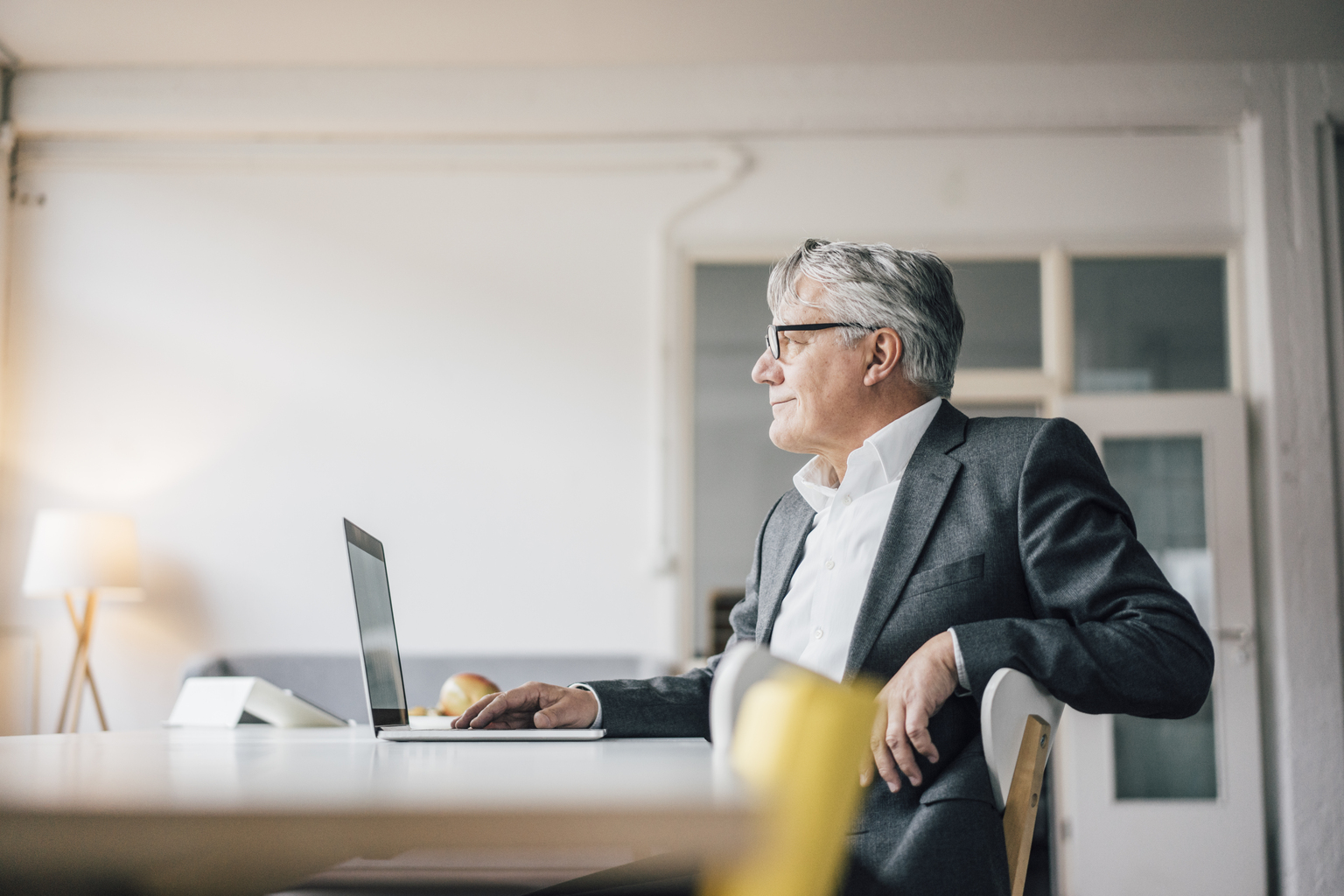 Confident senior businessman using laptop