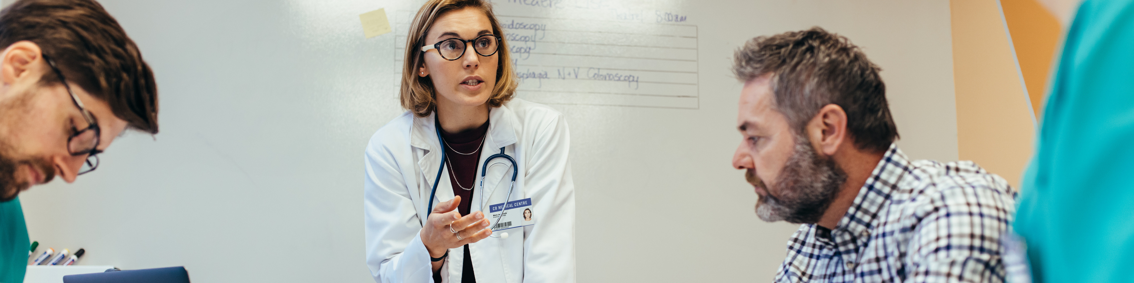 Female doctor briefing her colleagues in boardroom