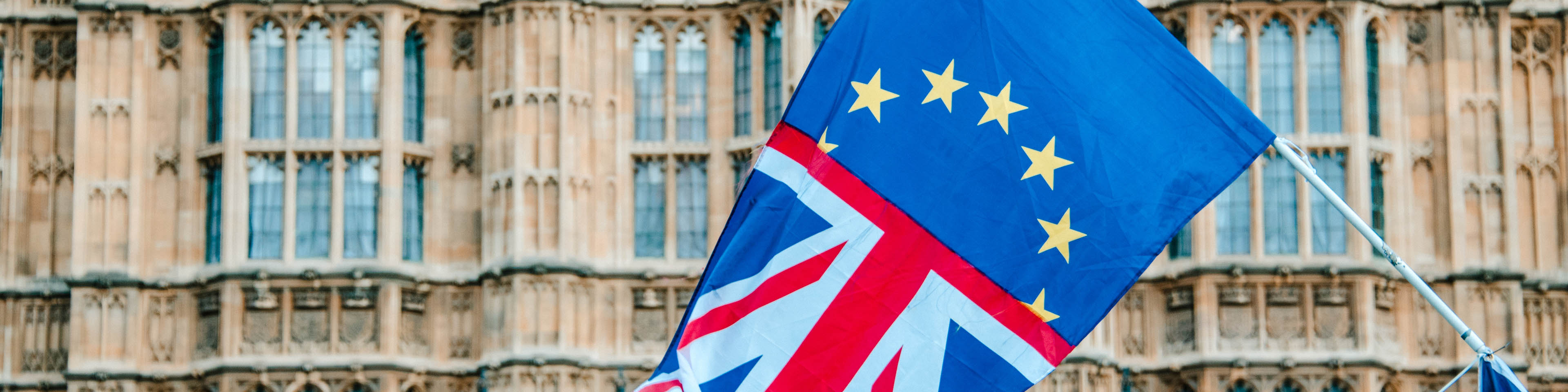 A flag merging the UK and EU flags by Houses of Parliament building in London