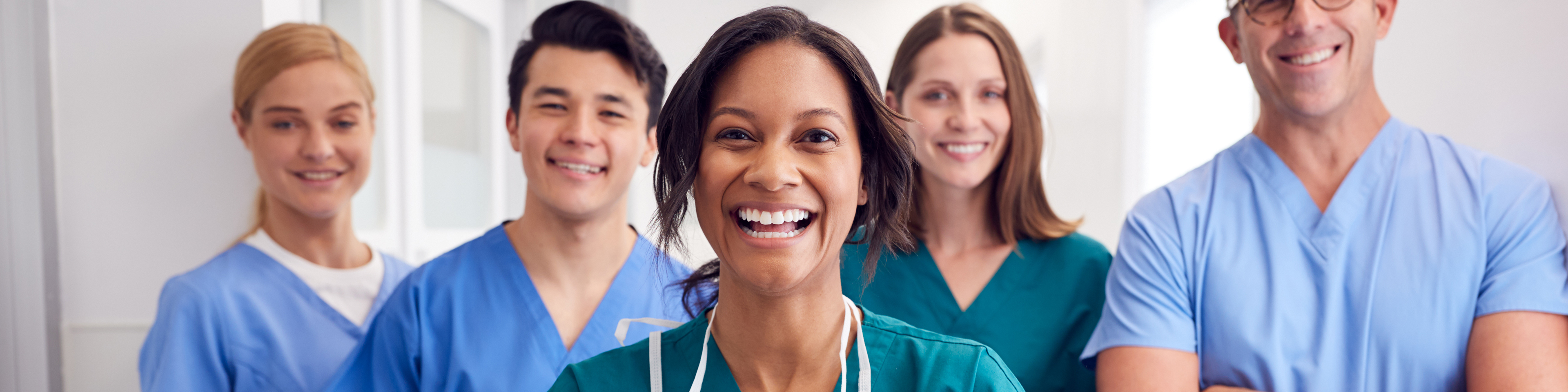 Group of healthcare workers standing in hospital hallway