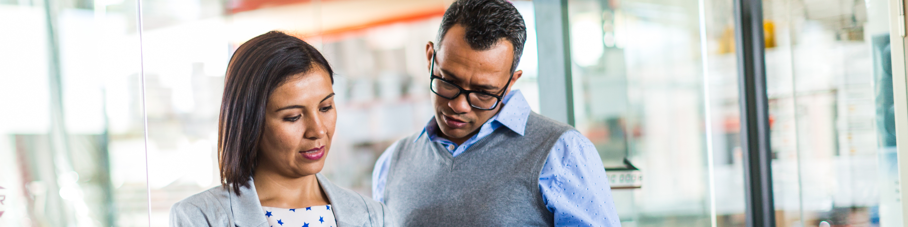 Two business colleagues reviewing tablet.