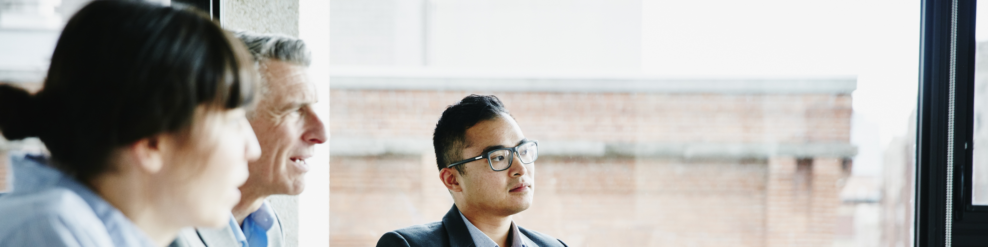 Businessman listening to presentation during project meeting in office