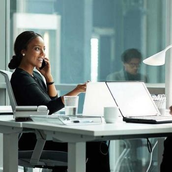 Woman on phone while with colleague