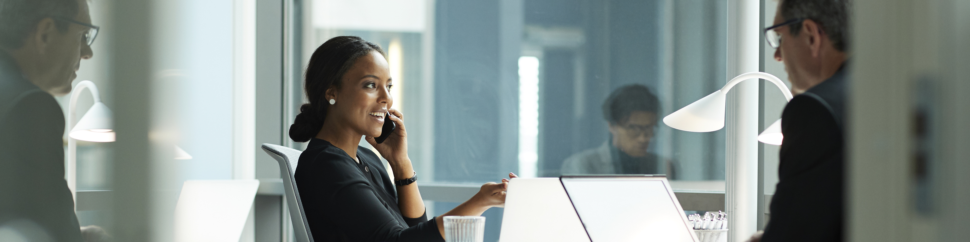 Business woman talking on the phone while working in the office