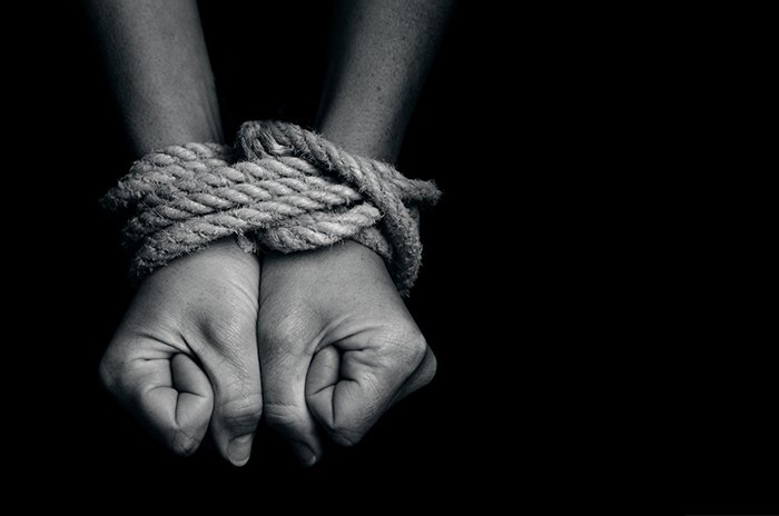 Hands tied together with thick rope