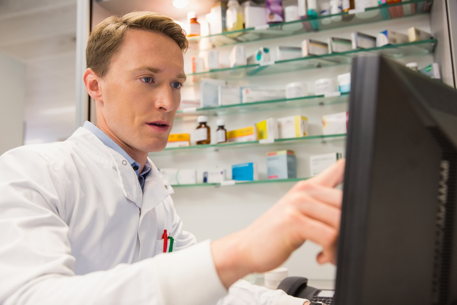 Focused pharmacist using the computer