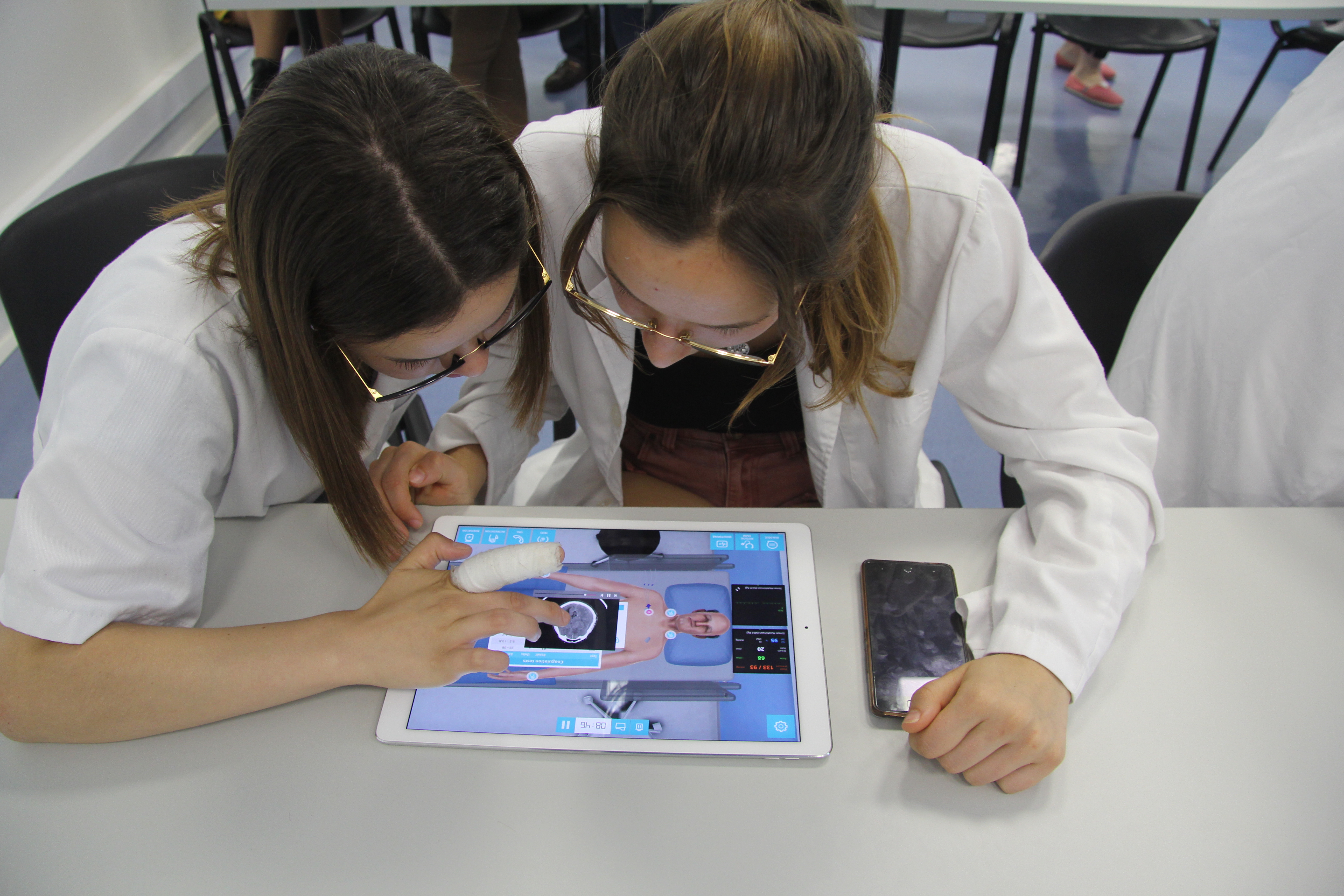 Two students using Body Interact on a tablet in a classroom setting