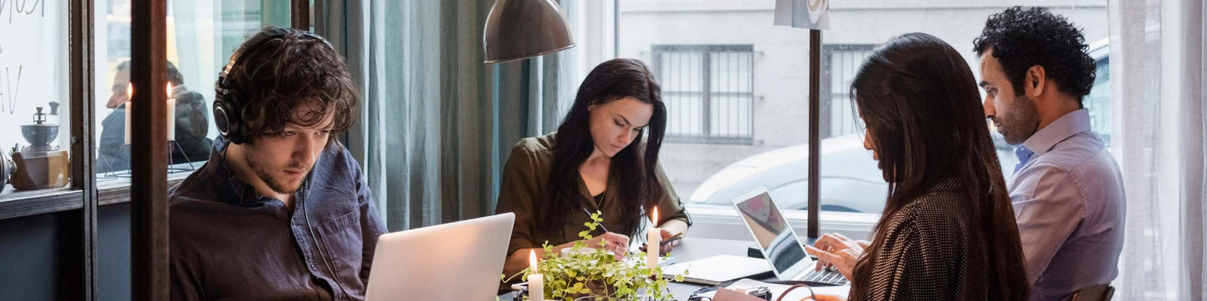 Male and female bloggers working at table in modern office