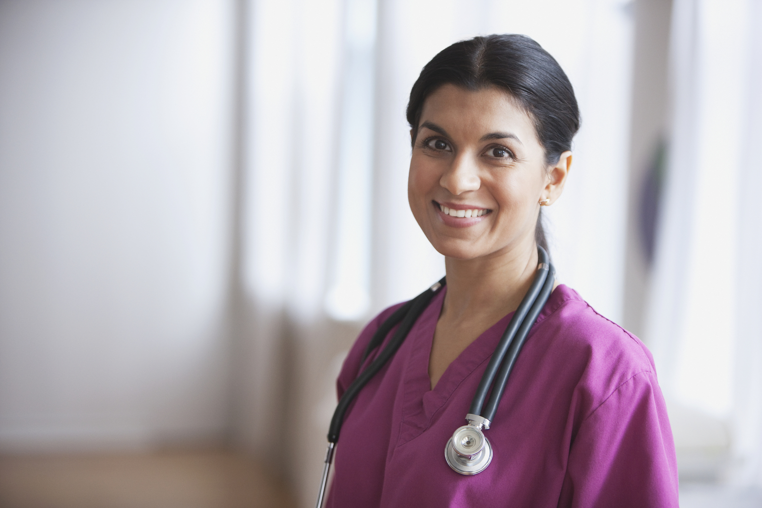 Mixed race doctor standing in hospital hallway