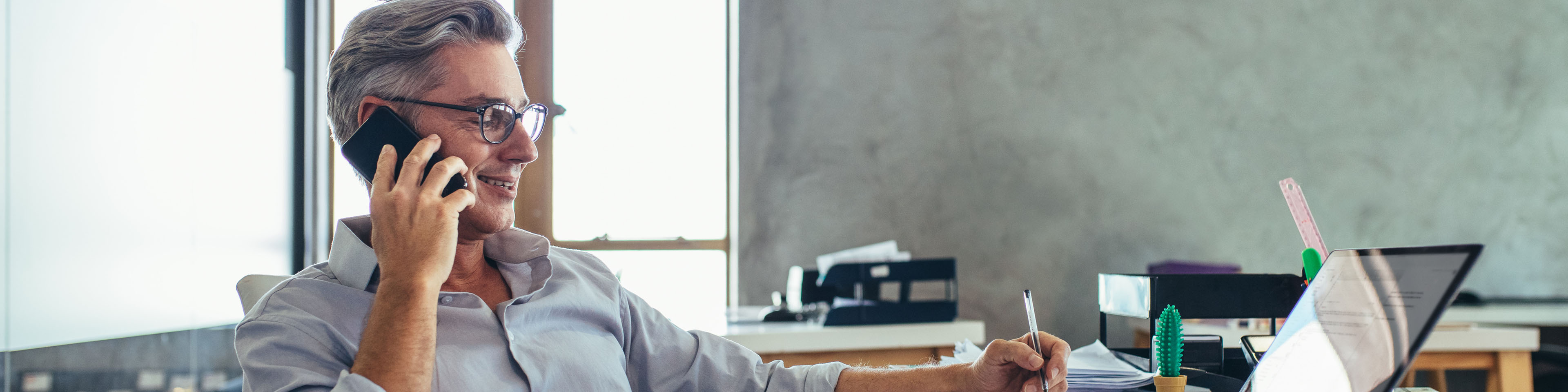 Businessman-in-office-talking-on-phone