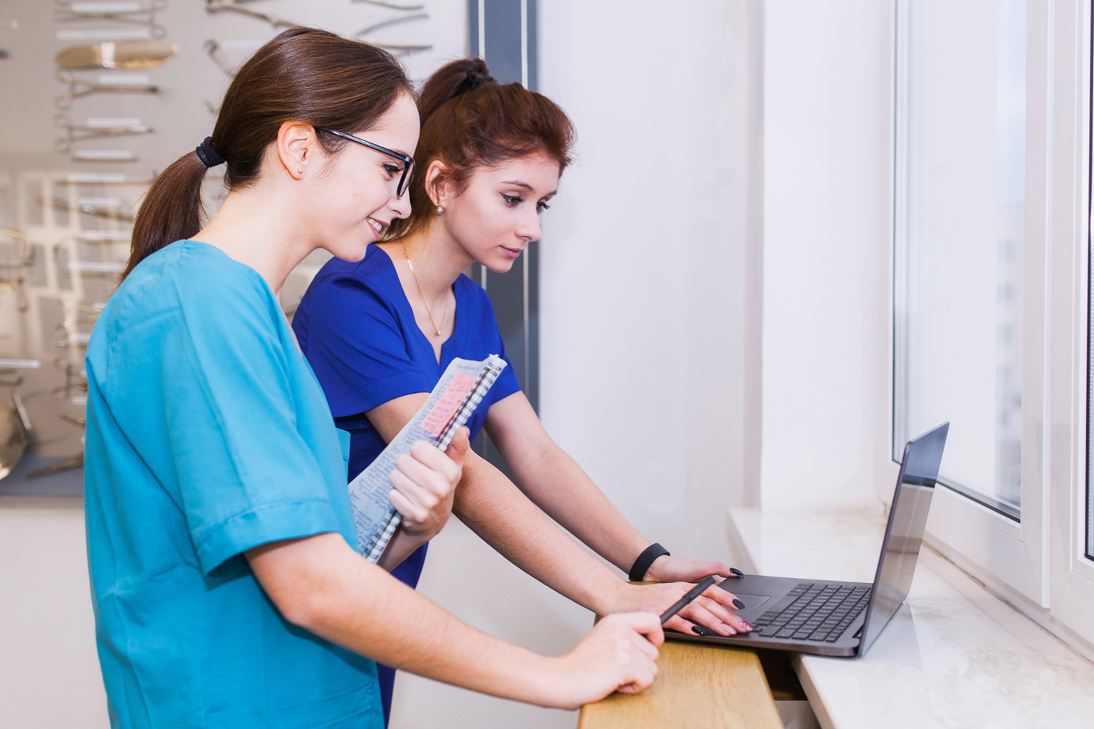 Group of nurse medical students discussion in front of laptop