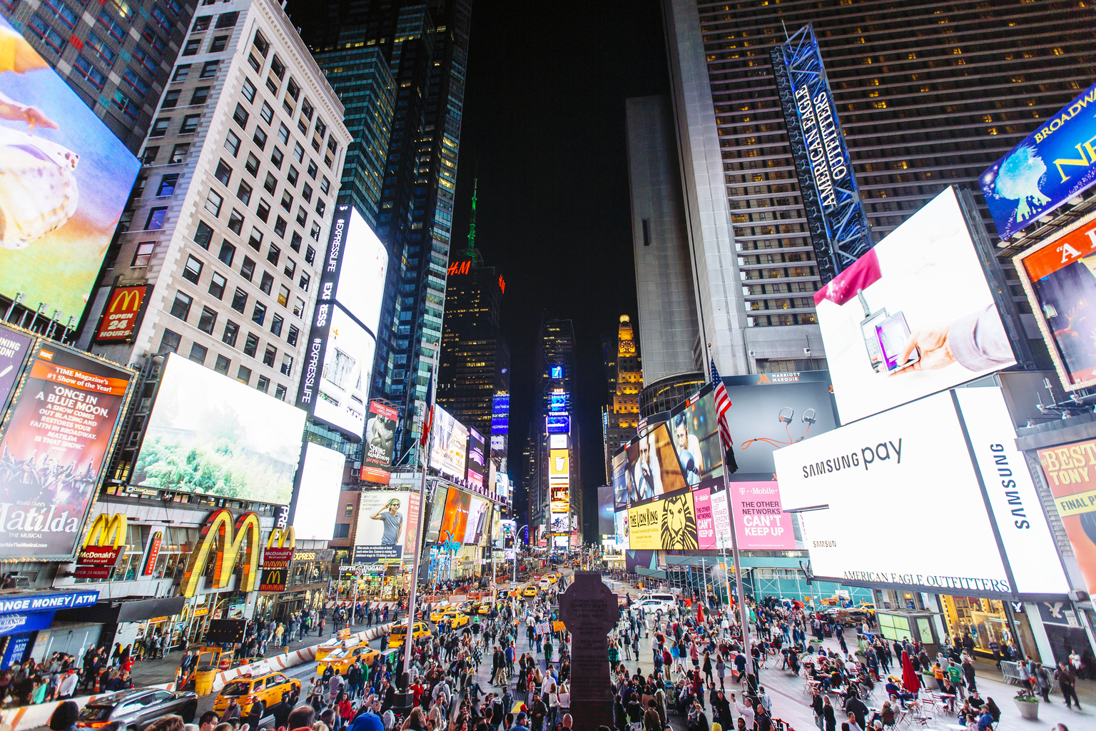 Times Square with illuminated billboards and advertisement at night, New York City, USA,