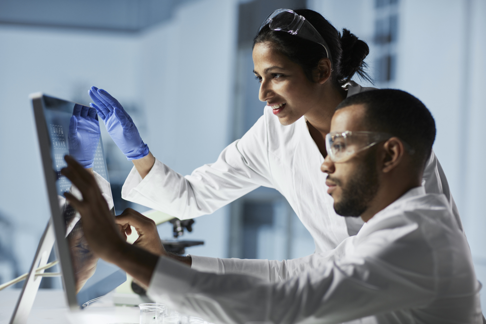 Scientists Working on Computer In Modern Laboratory