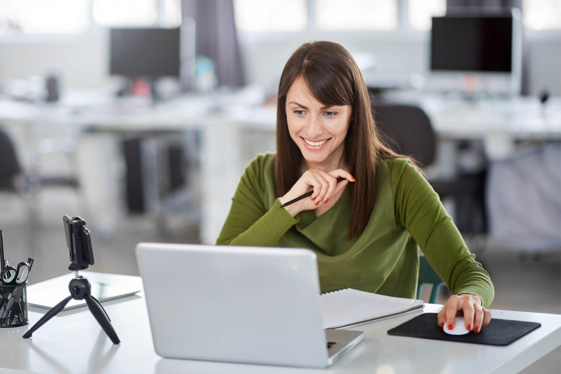 happy auditor at desk working on laptop