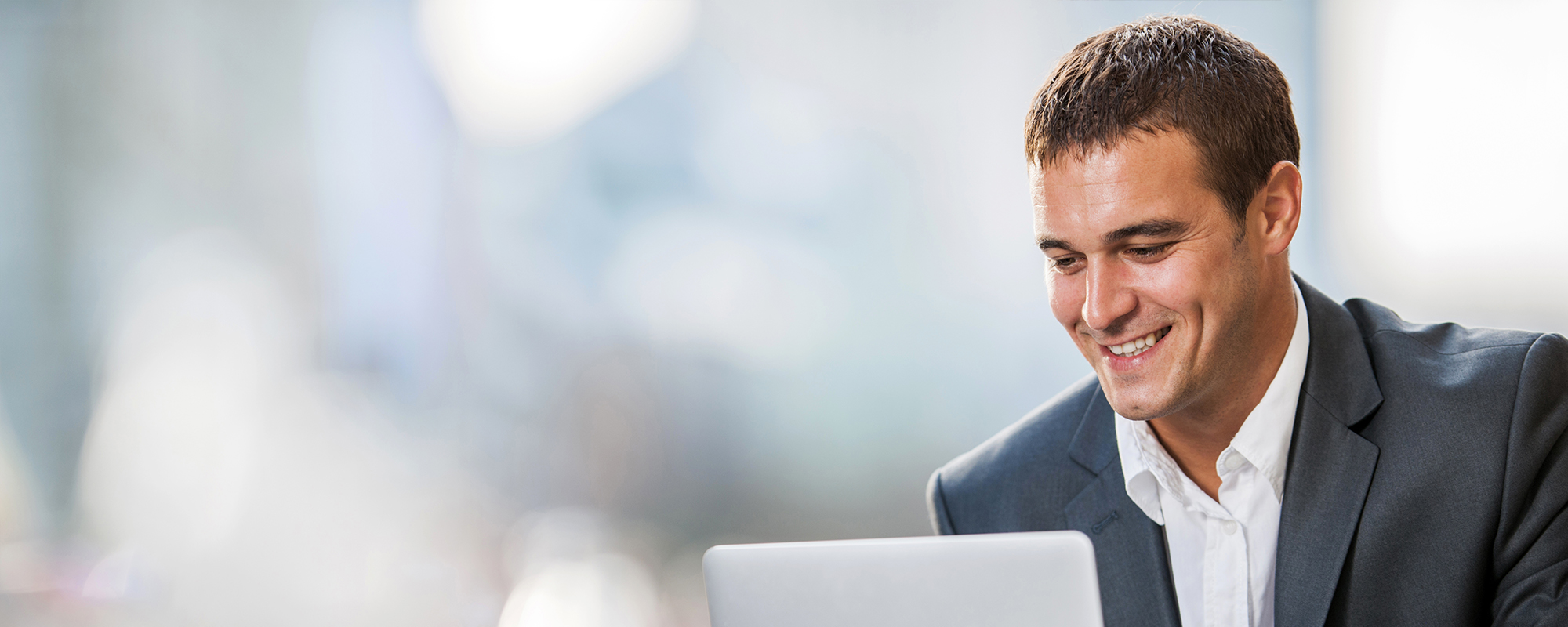 Man looking at computer, using Wolters Kluwer Solutions