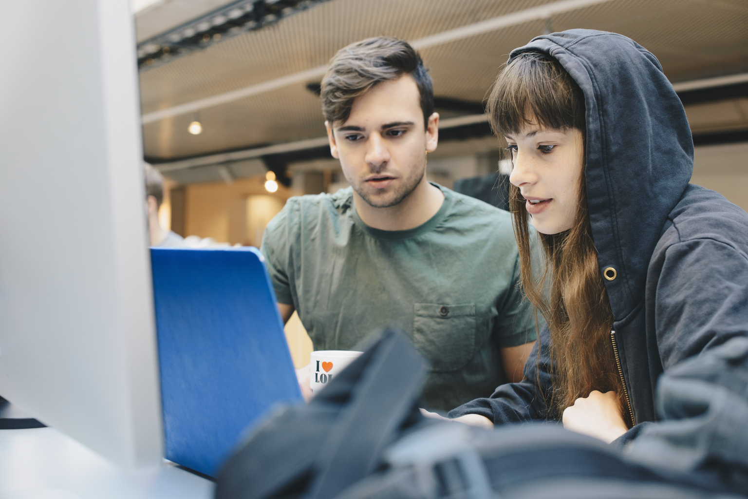 Two students working together on a project at university