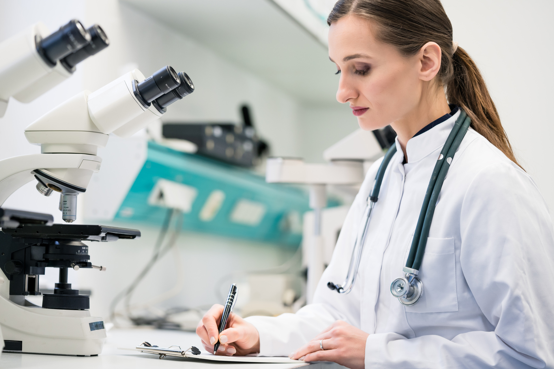 Lab worker collecting data at microscope