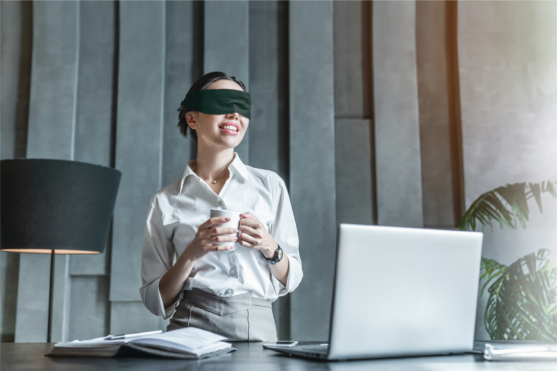 Blindfolded working business woman 