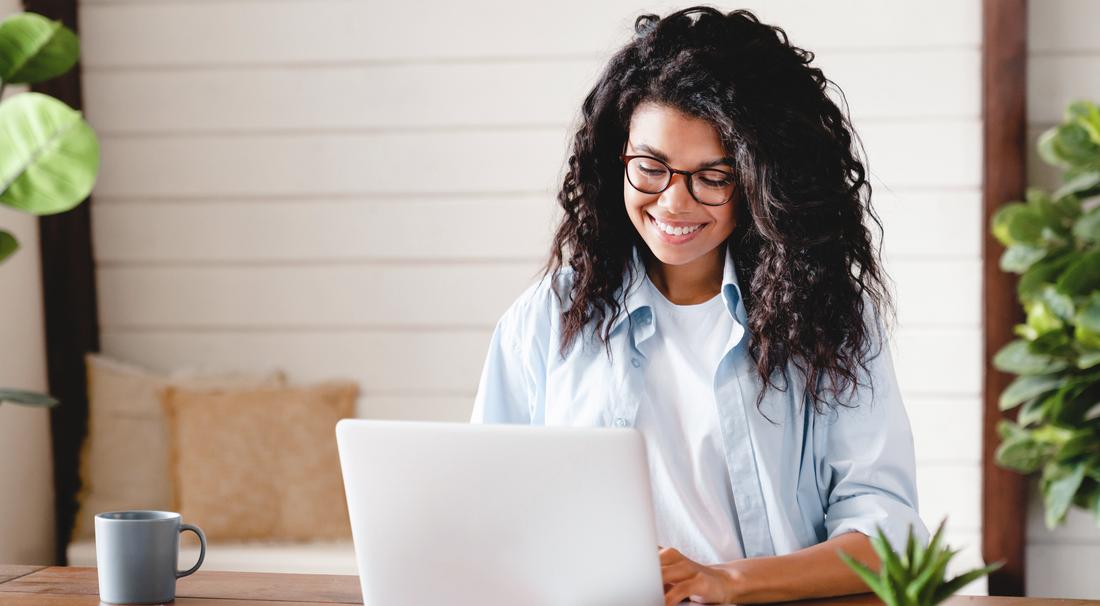 Young woman watching online education webinar using laptop.