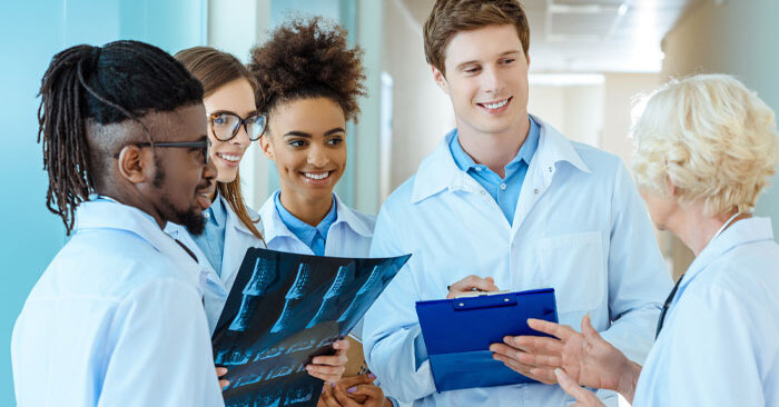 Group of medical students in hallway with instructor