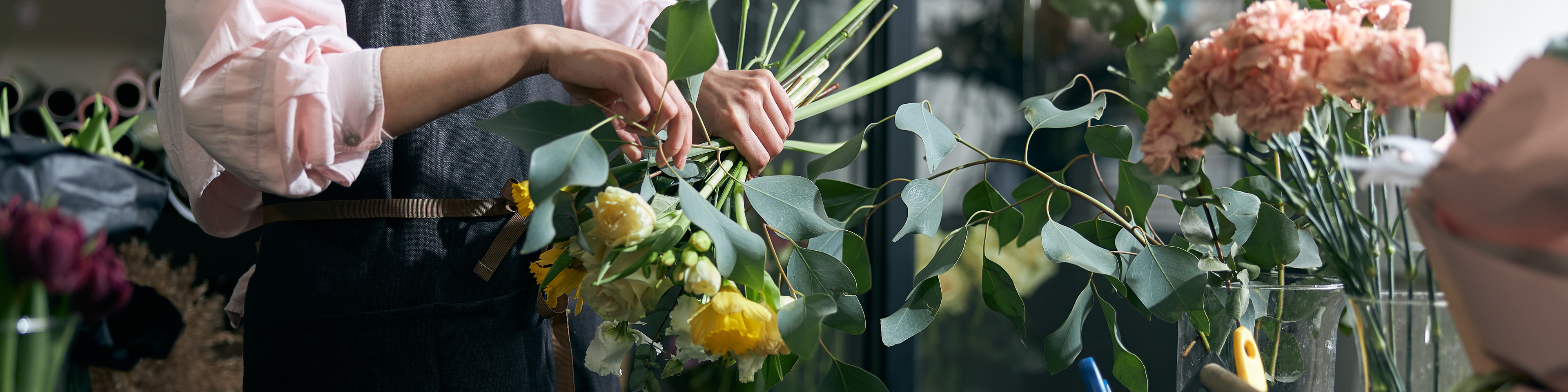 florist holding beautiful flowers in flower shop