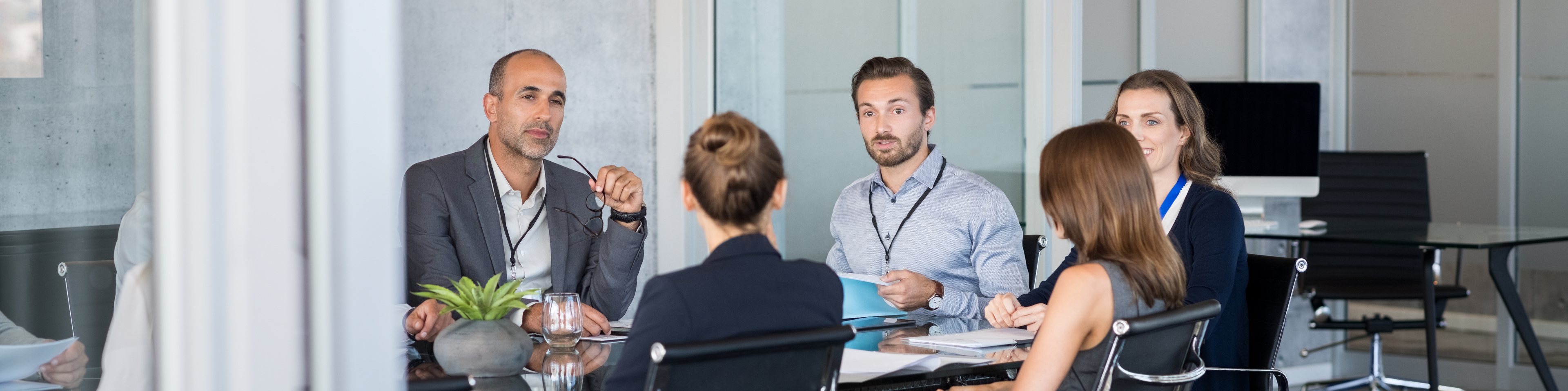 Business people sitting in boardroom and working together at new strategy plan. Group of leader and businesspeople in a meeting at office. Senior executive with his team working in a conference room.