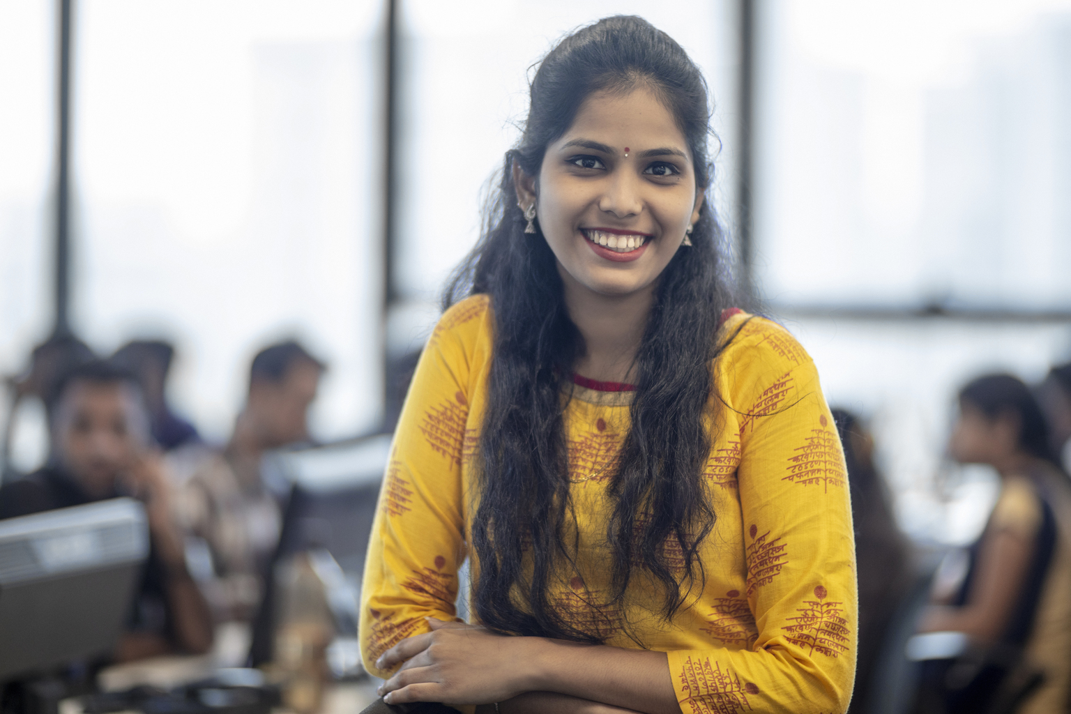 Portrait of beautiful young businesswoman standing at workplace