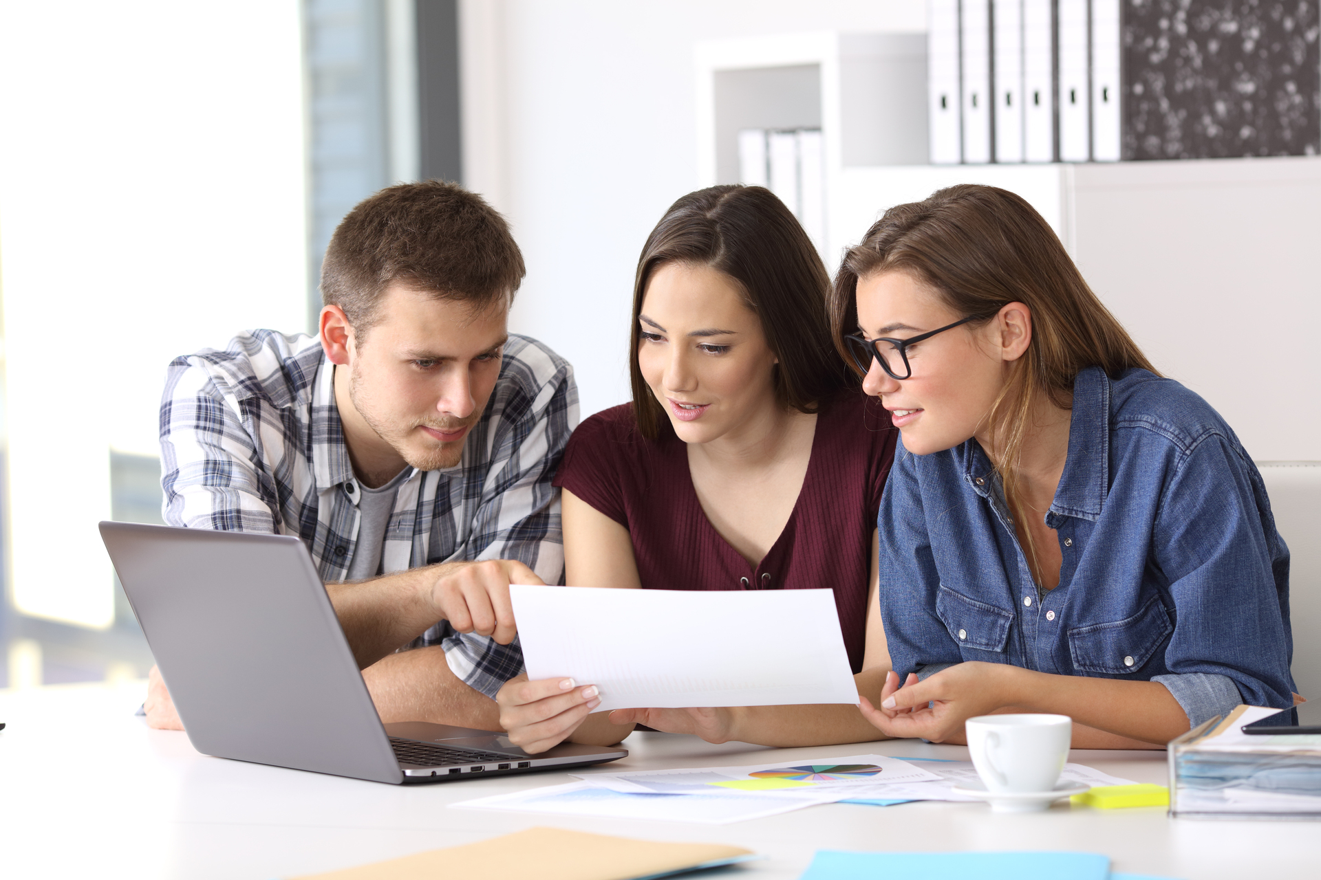 People analyzing reports with the team.