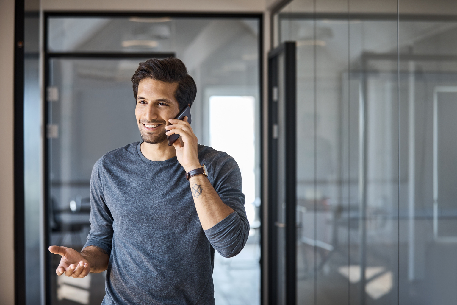 Entrepreneur talking on mobile phone at office