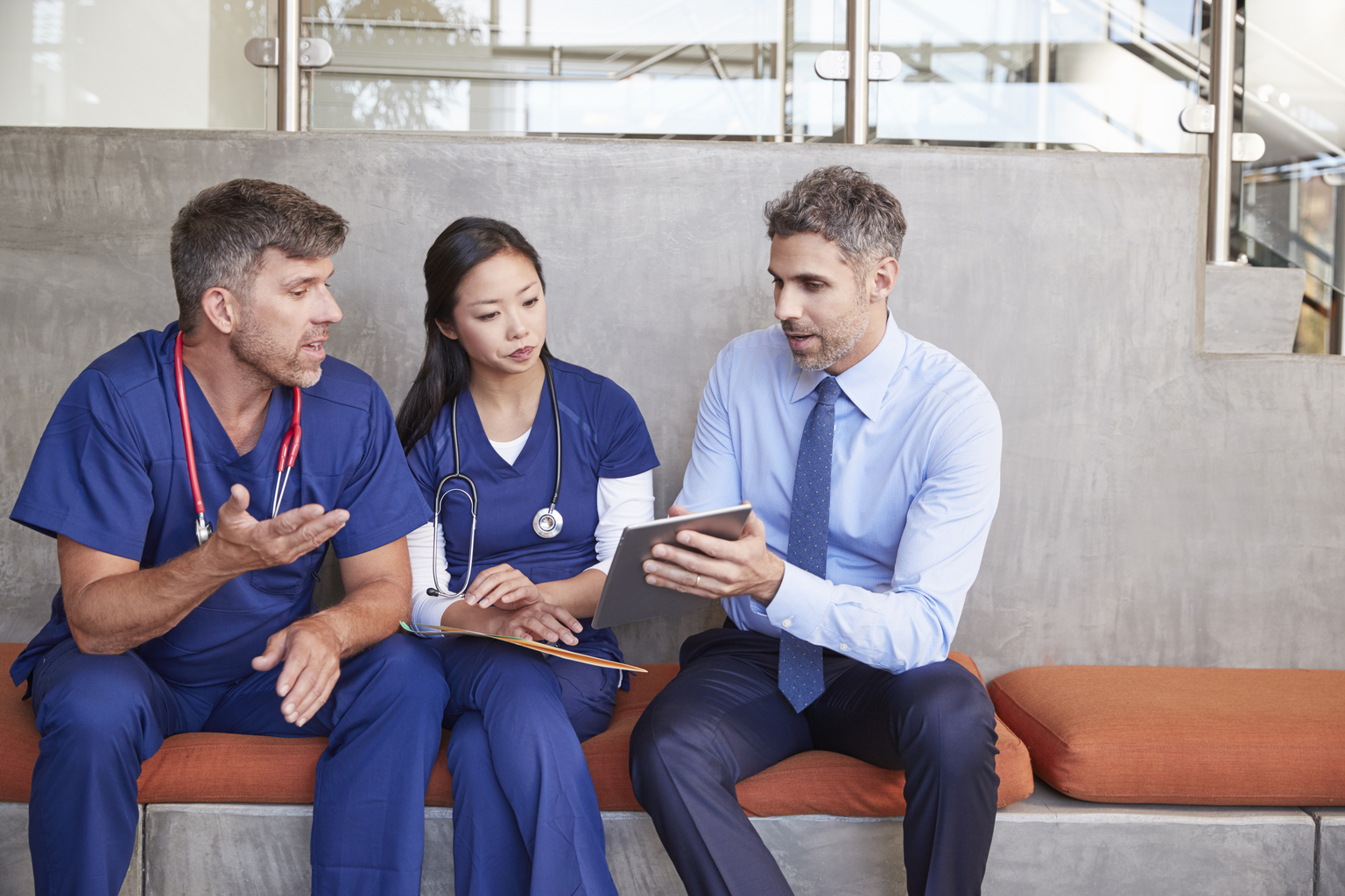 Doctors sitting on a bench talking