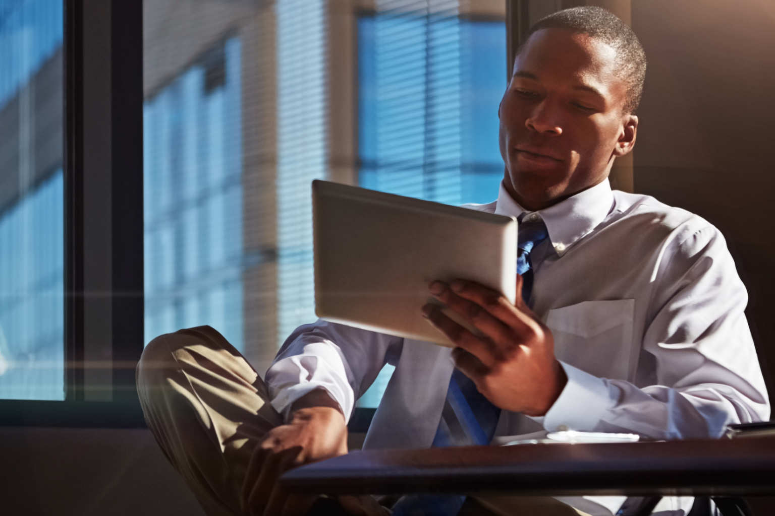 sitting man holds tablet