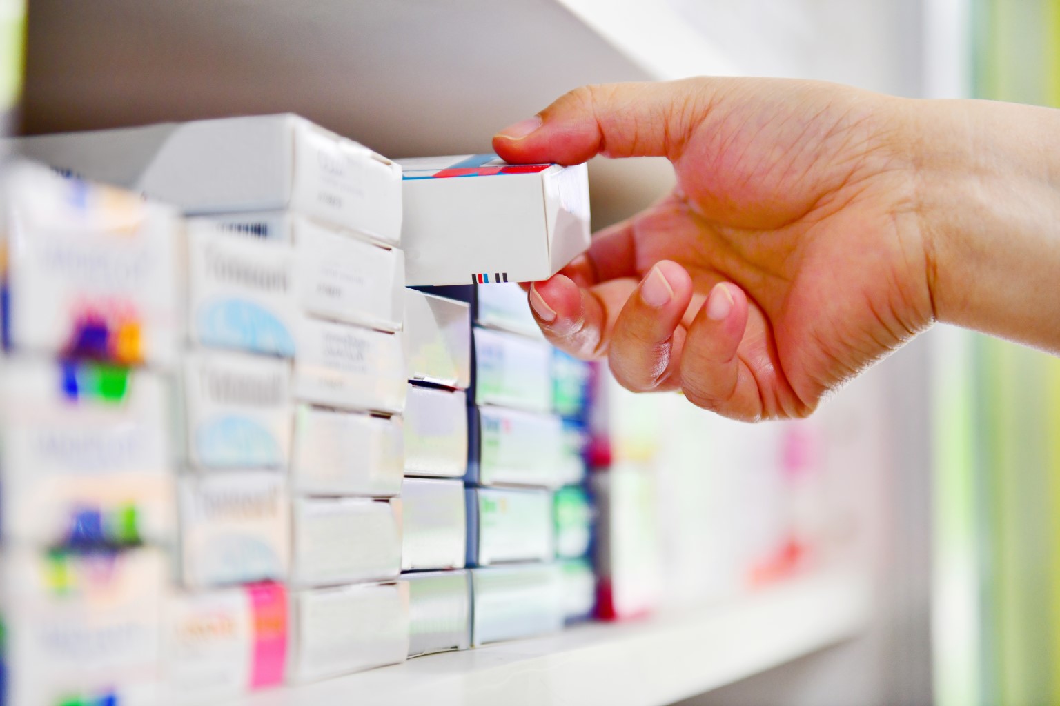Pharmacist selecting medication