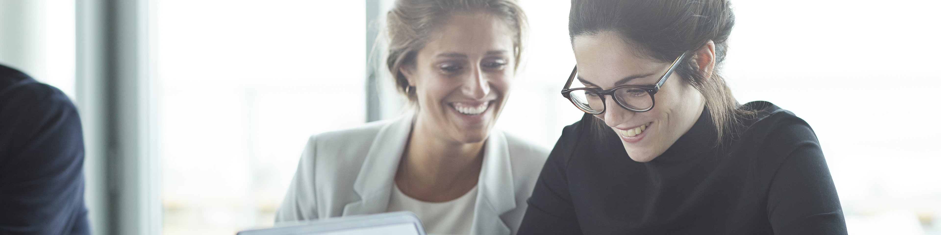 Female colleagues discussing over a coffee.