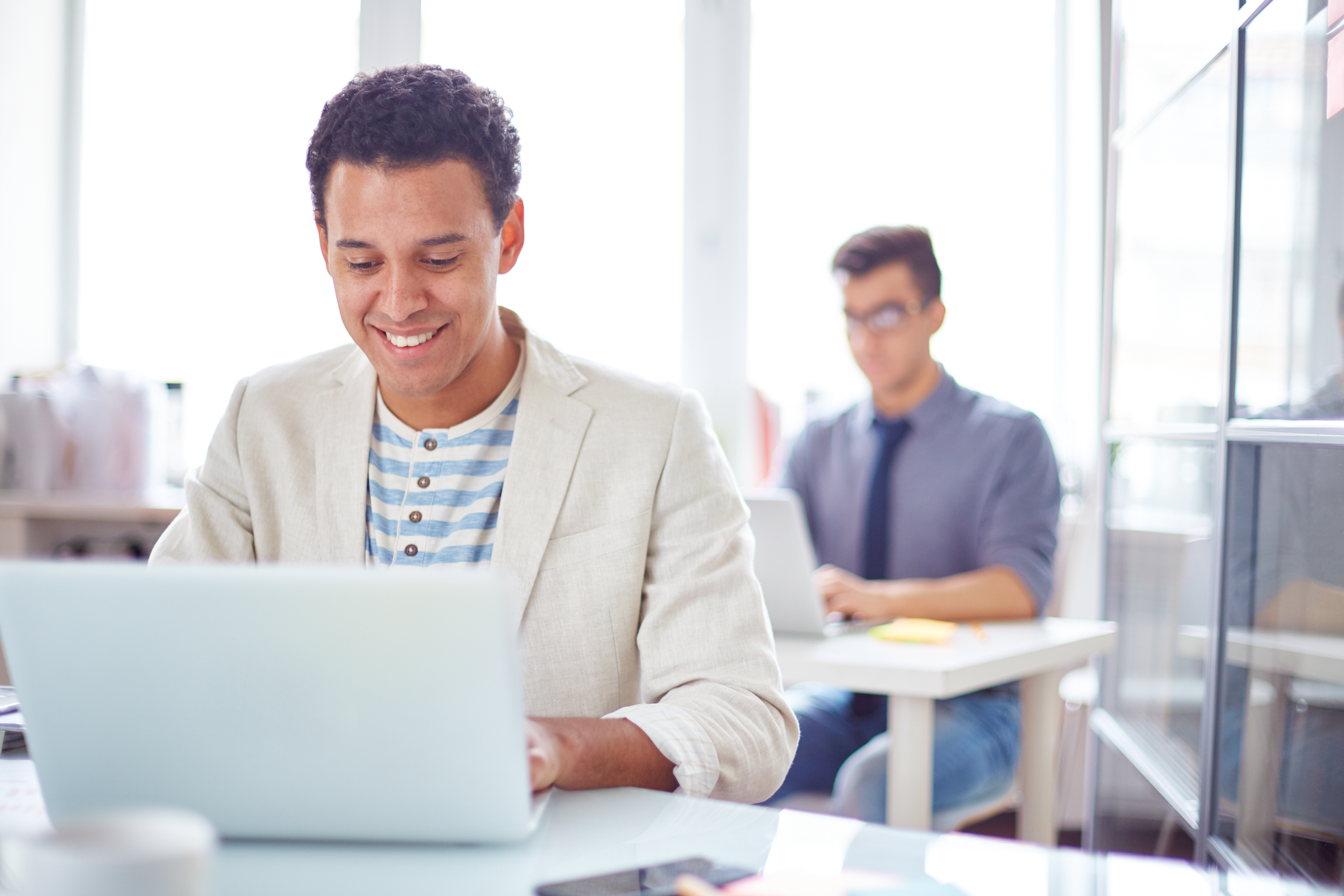 Business professional works on laptop.