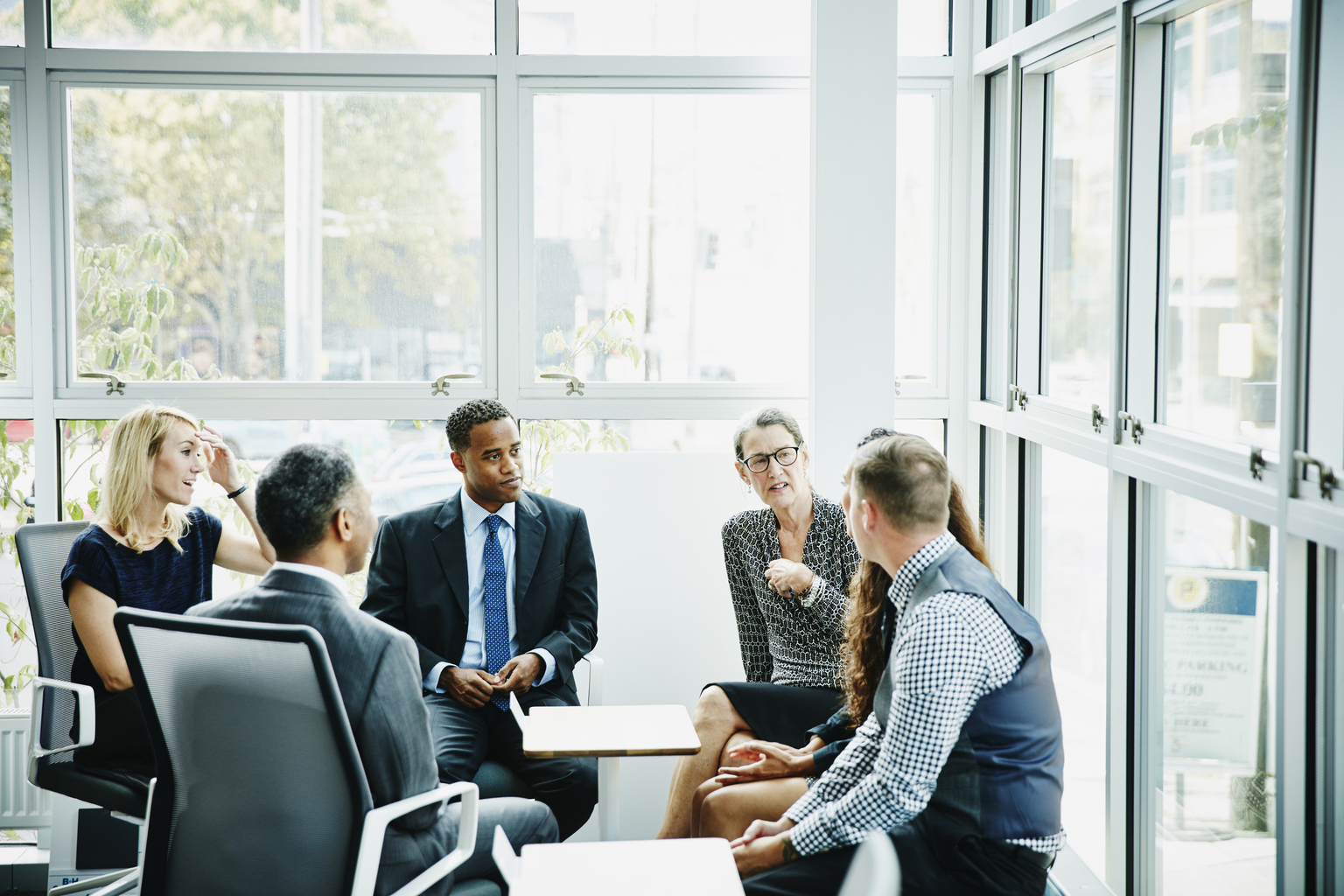 Mature business woman leading team meeting in conference room