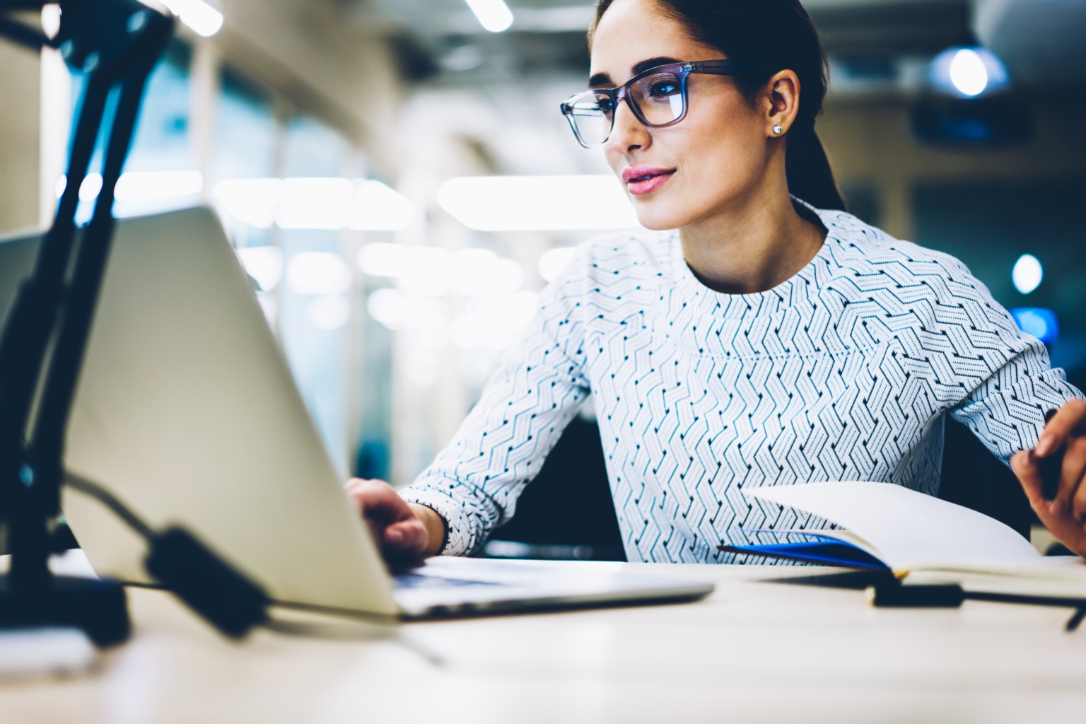 A woman using a laptop as part of an efficient AI-enabled tax workflow