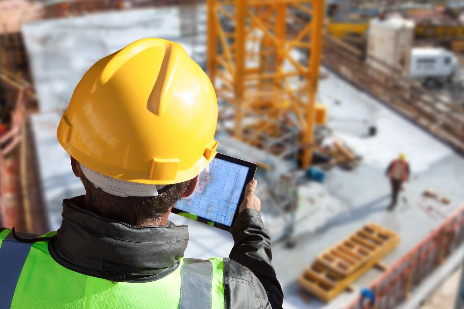 architect engineer construction worker with hard hat working on site with tablet computer