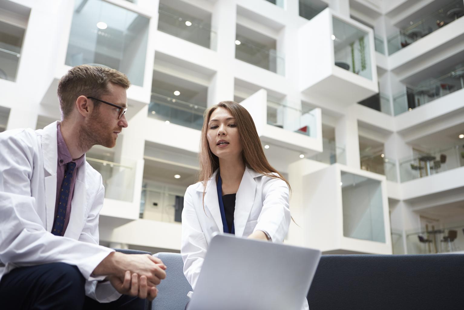 Two doctors having meeting in hospital reception