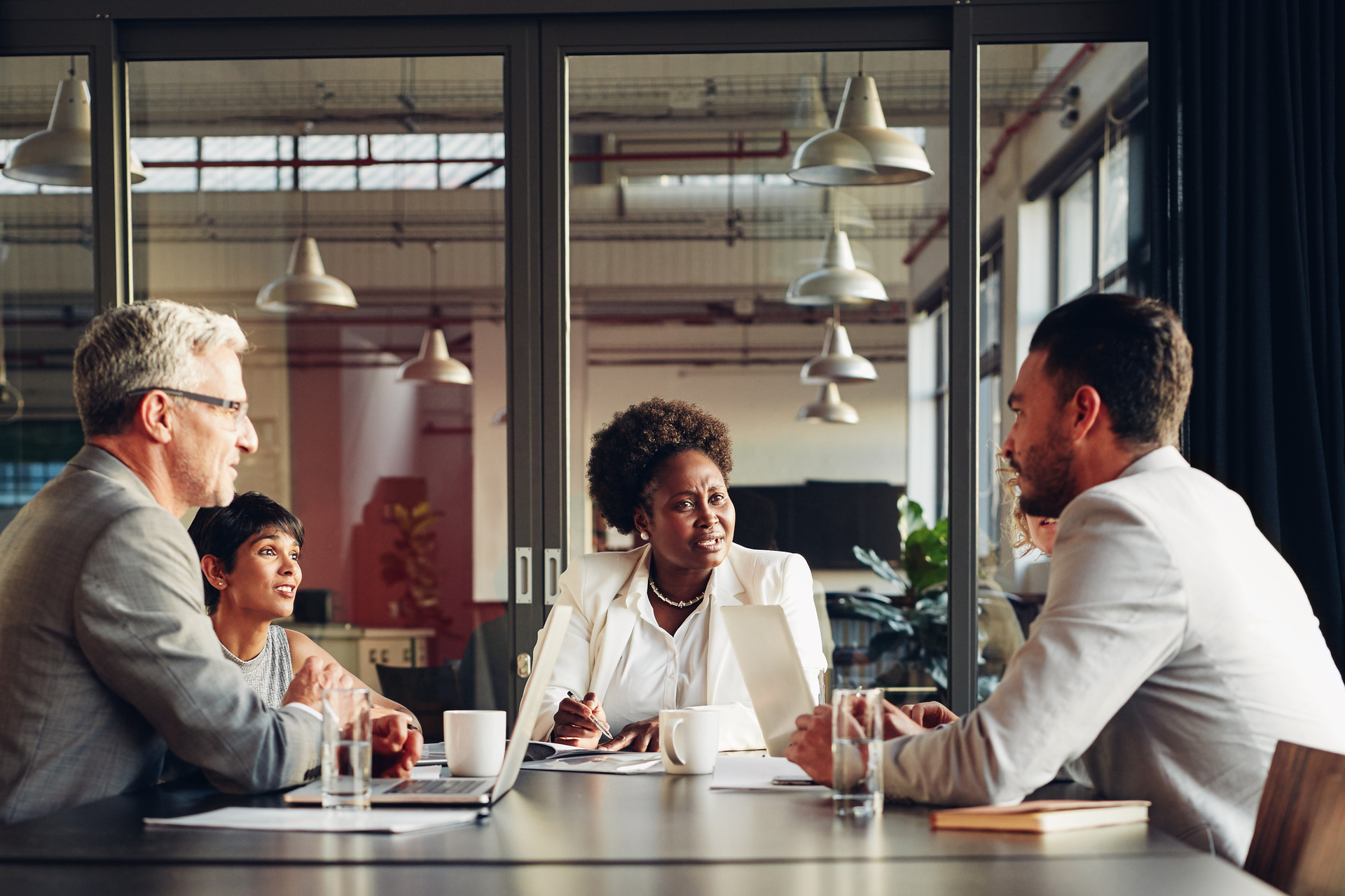 African American businesswoman listening to her team discussing work