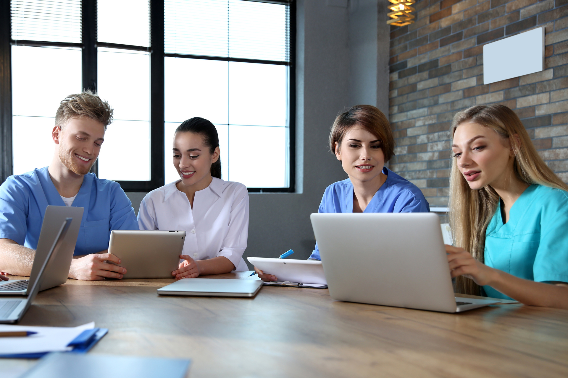 Group of smart medical students with gadgets in college