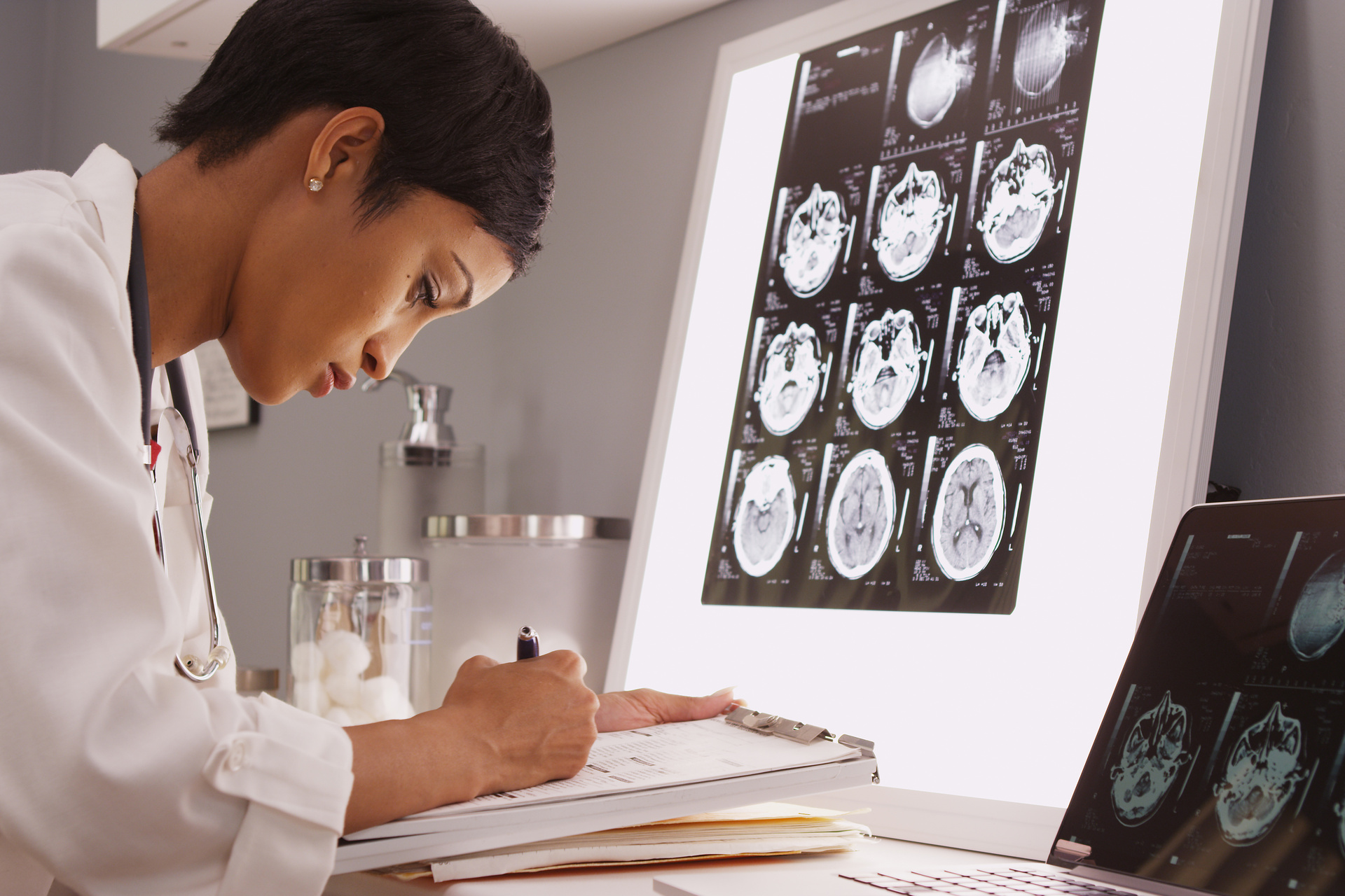 Black female doctor reading imaging scans