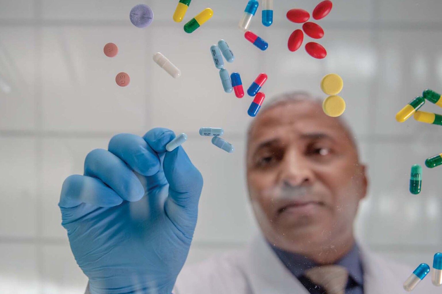 pharmacist sorting through a variety of pills