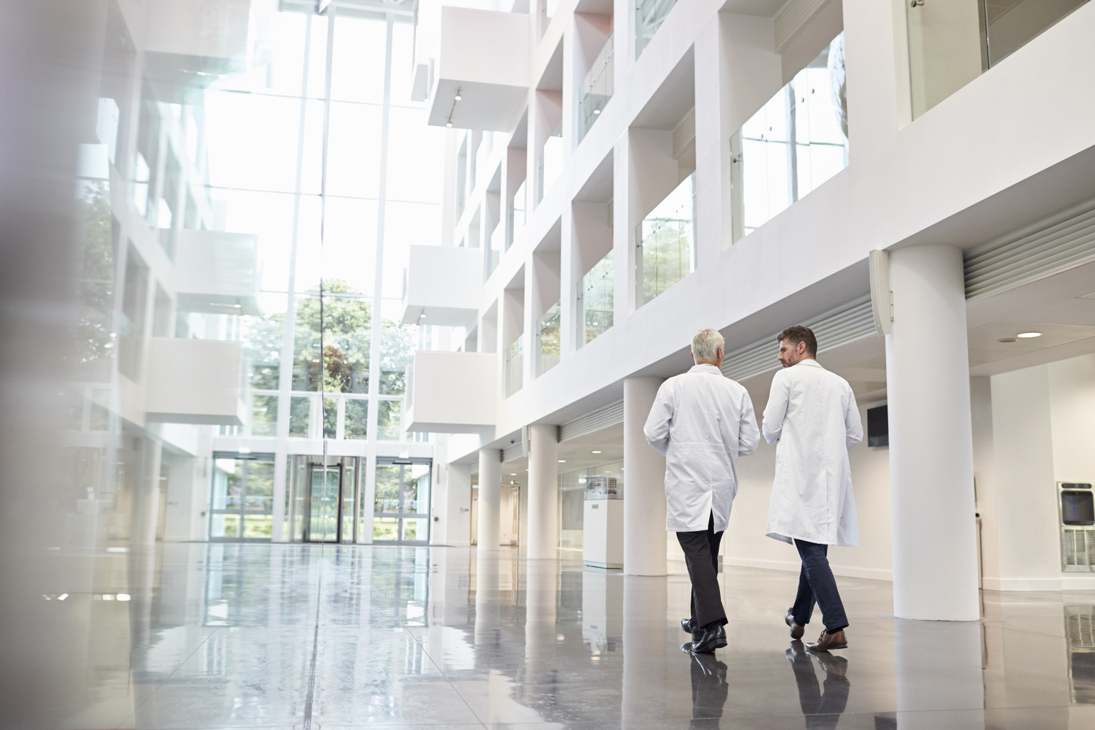 pair of doctors walking in hallway