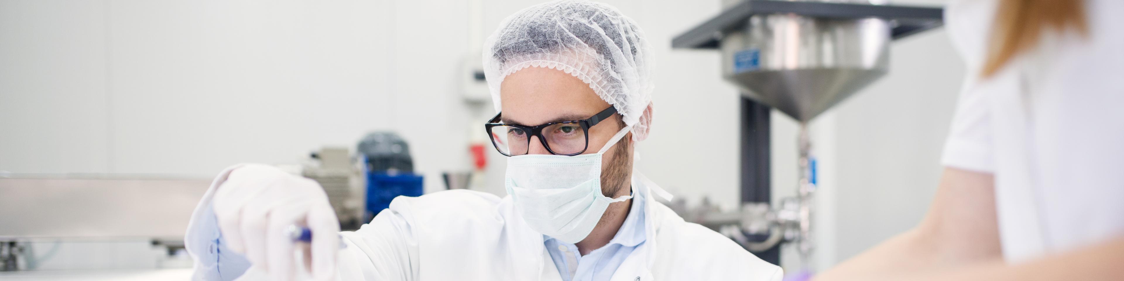 A scientist working in a licensed drug manufacturer's lab.
