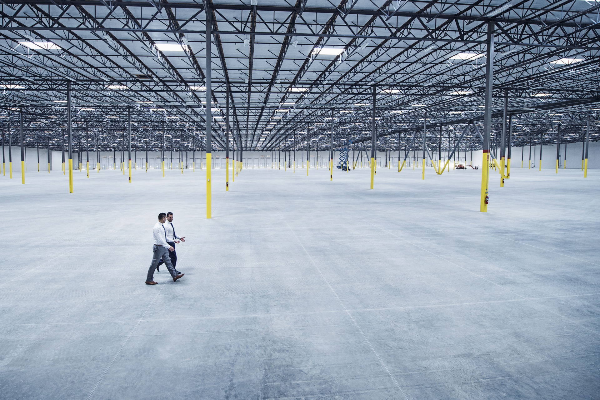 Businessmen walking in empty warehouse