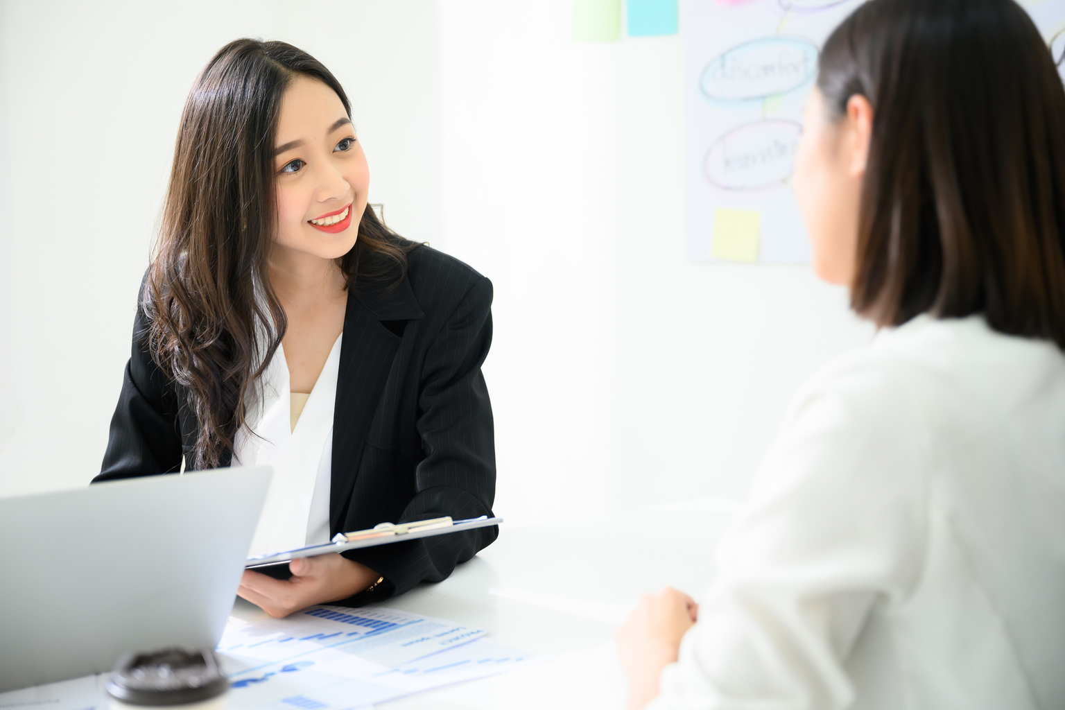 Young asian businesswoman talking applicant