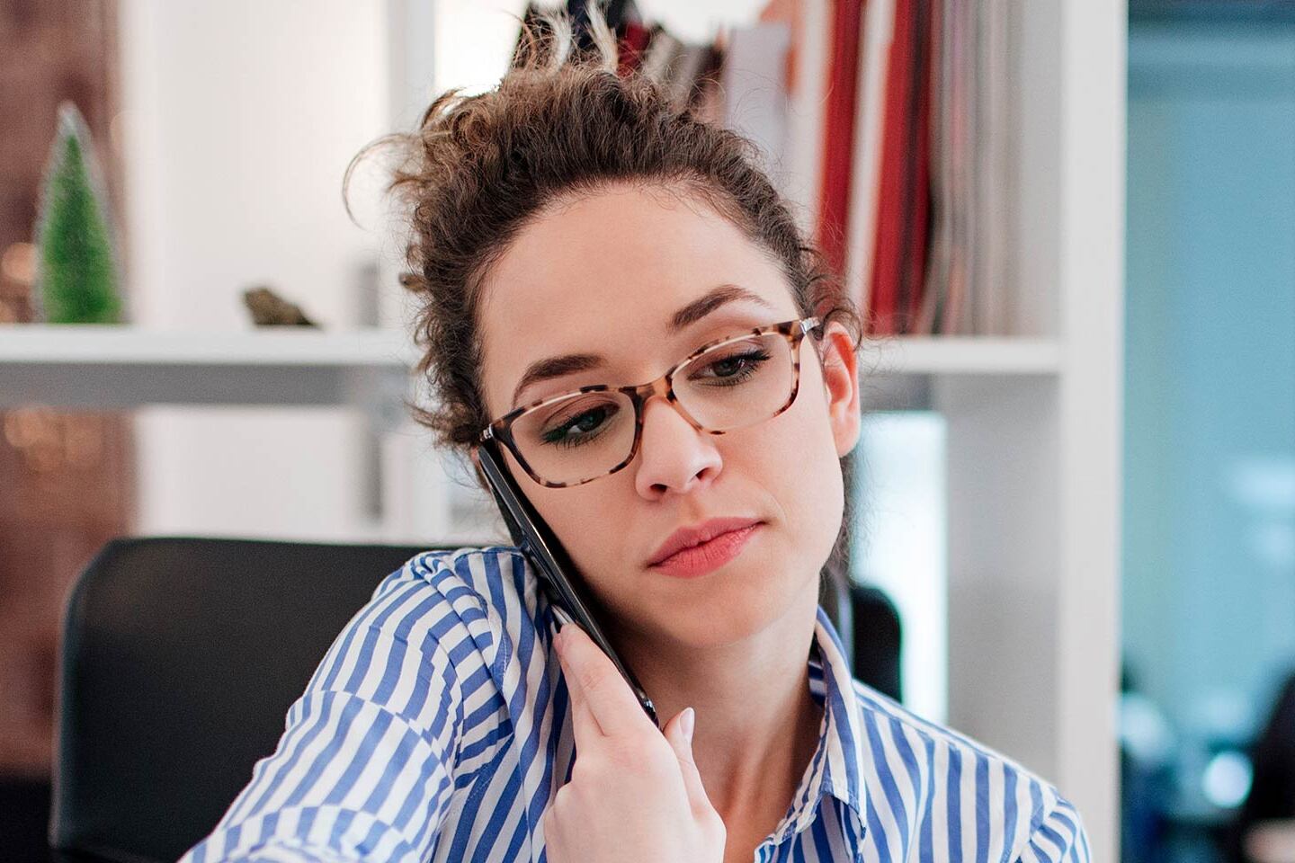 Woman working from home, talking on the phone