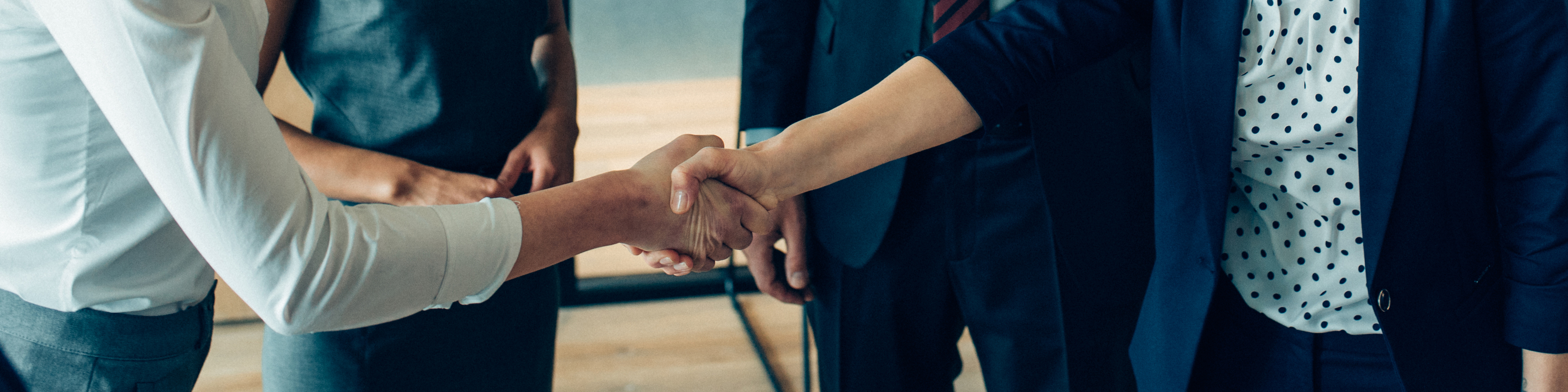 Business people shaking hands after the meeting.